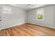 Bright bedroom with hardwood floors, two windows, and recessed lighting at 1005 Forrestal Pl, Durham, NC 27707