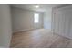 Bright bedroom features hardwood floors, neutral paint, and a window at 1005 Forrestal Pl, Durham, NC 27707