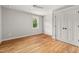 Cozy bedroom featuring hardwood floors, ample light, and double door closet at 1005 Forrestal Pl, Durham, NC 27707