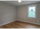 New bedroom with hardwood floors, neutral paint, and a large window offering natural light at 1005 Forrestal Pl, Durham, NC 27707