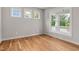 Empty bedroom with hardwood floors and a large window offering plenty of natural light at 1005 Forrestal Pl, Durham, NC 27707