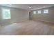 Spacious bedroom with natural light from large windows and a ceiling fan, offering a comfortable living space at 1005 Forrestal Pl, Durham, NC 27707