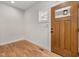 Bright entryway with a wooden front door, hardwood floors, and white walls at 1005 Forrestal Pl, Durham, NC 27707
