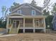 Charming two-story home with a covered front porch and wood railings at 1005 Forrestal Pl, Durham, NC 27707
