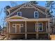New construction craftsman-style home featuring a covered front porch with classic columns and a shingle facade at 1005 Forrestal Pl, Durham, NC 27707