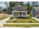 Beautiful two-story home boasts a large, well-maintained lawn and inviting front porch at 1005 Forrestal Pl, Durham, NC 27707