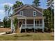 Charming two-story home with a welcoming front porch and neatly landscaped front yard at 1005 Forrestal Pl, Durham, NC 27707