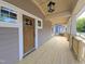 Spacious front porch with wood flooring and a hanging lantern at 1005 Forrestal Pl, Durham, NC 27707