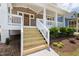 Inviting front porch with detailed white railings and wood stairs leading to the front door at 1005 Forrestal Pl, Durham, NC 27707