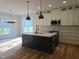 Modern kitchen with an island, stainless steel appliances, and white cabinetry at 1005 Forrestal Pl, Durham, NC 27707