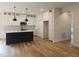 Modern kitchen with an island, stainless steel appliances, and white cabinetry at 1005 Forrestal Pl, Durham, NC 27707