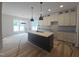 Open kitchen with a center island, modern light fixtures, and stylish cabinetry, perfect for cooking at 1005 Forrestal Pl, Durham, NC 27707