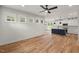 Open-concept living area with hardwood floors flowing into a modern kitchen with an island at 1005 Forrestal Pl, Durham, NC 27707