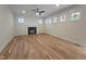 Bright living room featuring hardwood floors, recessed lighting, a ceiling fan, and a fireplace with a white mantle at 1005 Forrestal Pl, Durham, NC 27707
