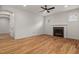 Spacious living room with hardwood floors, fireplace, ceiling fan, and ample natural light at 1005 Forrestal Pl, Durham, NC 27707