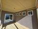 Covered porch with wood flooring and sliding glass doors and multiple windows at 1005 Forrestal Pl, Durham, NC 27707