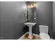 Contemporary powder room features a pedestal sink, modern fixtures, and neutral gray walls at 1005 Forrestal Pl, Durham, NC 27707