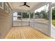 Spacious screened porch with wood flooring, ceiling fan, and scenic outdoor views at 1005 Forrestal Pl, Durham, NC 27707