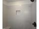 Modern shower with gray tiled walls, a built-in niche, and matte black fixtures, creating a spa-like experience at 1005 Forrestal Pl, Durham, NC 27707