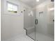 Glass enclosed shower featuring tiled walls, built-in niche, and convenient bench seating at 1005 Forrestal Pl, Durham, NC 27707
