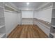Large walk-in closet with built-in shelving and hardwood floors at 1005 Forrestal Pl, Durham, NC 27707