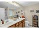 Bathroom with double sinks, wood cabinets, large mirror, and a tiled shower at 101 Hay Sedge Ct, Durham, NC 27705