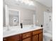 Bright bathroom featuring a double vanity, large mirror and bathtub with a shower at 101 Hay Sedge Ct, Durham, NC 27705