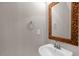 Bathroom with an ornate mirror and a pedestal sink, with neutral colored walls at 101 Hay Sedge Ct, Durham, NC 27705