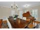 Bright dining room with a grand piano, a dining table, and a stylish chandelier at 101 Hay Sedge Ct, Durham, NC 27705