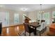 Elegant dining room featuring a grand piano, hardwood floors, and a large dining table at 101 Hay Sedge Ct, Durham, NC 27705