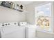 Bright laundry room includes a window, shelving and a washer and dryer at 101 Hay Sedge Ct, Durham, NC 27705