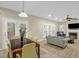 Open living room with a fireplace, ample natural light, and tile flooring at 101 Hay Sedge Ct, Durham, NC 27705