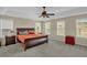 Comfortable main bedroom boasting a tray ceiling, plush carpeting, and natural light at 101 Hay Sedge Ct, Durham, NC 27705