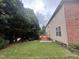 Scenic backyard with a well-maintained lawn, tall trees, and a charming deck with stairs at 102 Revere Forest Ct, Cary, NC 27519