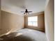 Large bedroom with carpet, neutral colors and a ceiling fan and large window at 102 Revere Forest Ct, Cary, NC 27519