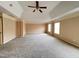Spacious bedroom featuring neutral carpeting, ceiling fan, trey ceiling, and natural light from multiple windows at 102 Revere Forest Ct, Cary, NC 27519