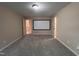 Spacious bonus room with carpet and a movie screen for entertainment at 102 Revere Forest Ct, Cary, NC 27519
