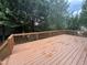 Spacious stained deck perfect for entertaining, surrounded by mature trees offering privacy at 102 Revere Forest Ct, Cary, NC 27519
