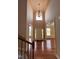 Grand foyer with soaring ceilings, hardwood floors, and views into the formal dining and living rooms at 102 Revere Forest Ct, Cary, NC 27519