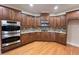 Gourmet kitchen with custom cabinets, granite countertops, and stainless steel appliances at 102 Revere Forest Ct, Cary, NC 27519