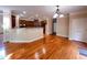 Open-concept kitchen and breakfast bar featuring wooden cabinetry and hardwood floors at 102 Revere Forest Ct, Cary, NC 27519