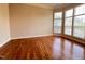 Spacious living room with hardwood floors and large windows letting in natural light at 102 Revere Forest Ct, Cary, NC 27519