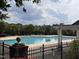 Community pool surrounded by lush greenery, offering a refreshing escape and social gathering space at 102 Revere Forest Ct, Cary, NC 27519