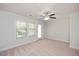 Spacious bedroom features neutral walls and carpet, with bright light from large windows and door at 103 Ballyliffen Ln, Cary, NC 27519
