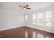 Bright bedroom features hardwood floors, natural light, and a ceiling fan at 103 Ballyliffen Ln, Cary, NC 27519