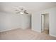 Spacious carpeted bedroom with neutral walls, ceiling fan, and two doors at 103 Ballyliffen Ln, Cary, NC 27519