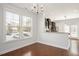 Well-lit dining room with hardwood floors and view to the kitchen at 103 Ballyliffen Ln, Cary, NC 27519