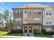 Two-story townhome featuring a brick facade, covered entrance, and well-maintained landscaping at 103 Ballyliffen Ln, Cary, NC 27519