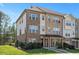Beautiful townhome showing brick and neutral siding, manicured lawn and covered entryway at 103 Ballyliffen Ln, Cary, NC 27519