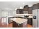 Gourmet kitchen featuring stainless steel appliances and a center island with granite countertop at 103 Ballyliffen Ln, Cary, NC 27519
